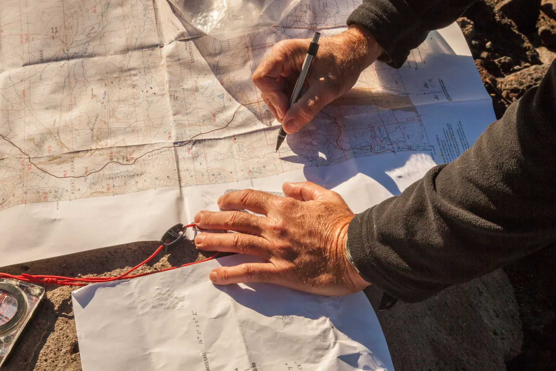 A hiker consults a topo map.